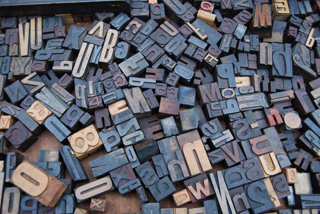 Scrambled different sizes of letters blocks used for old printing machines.